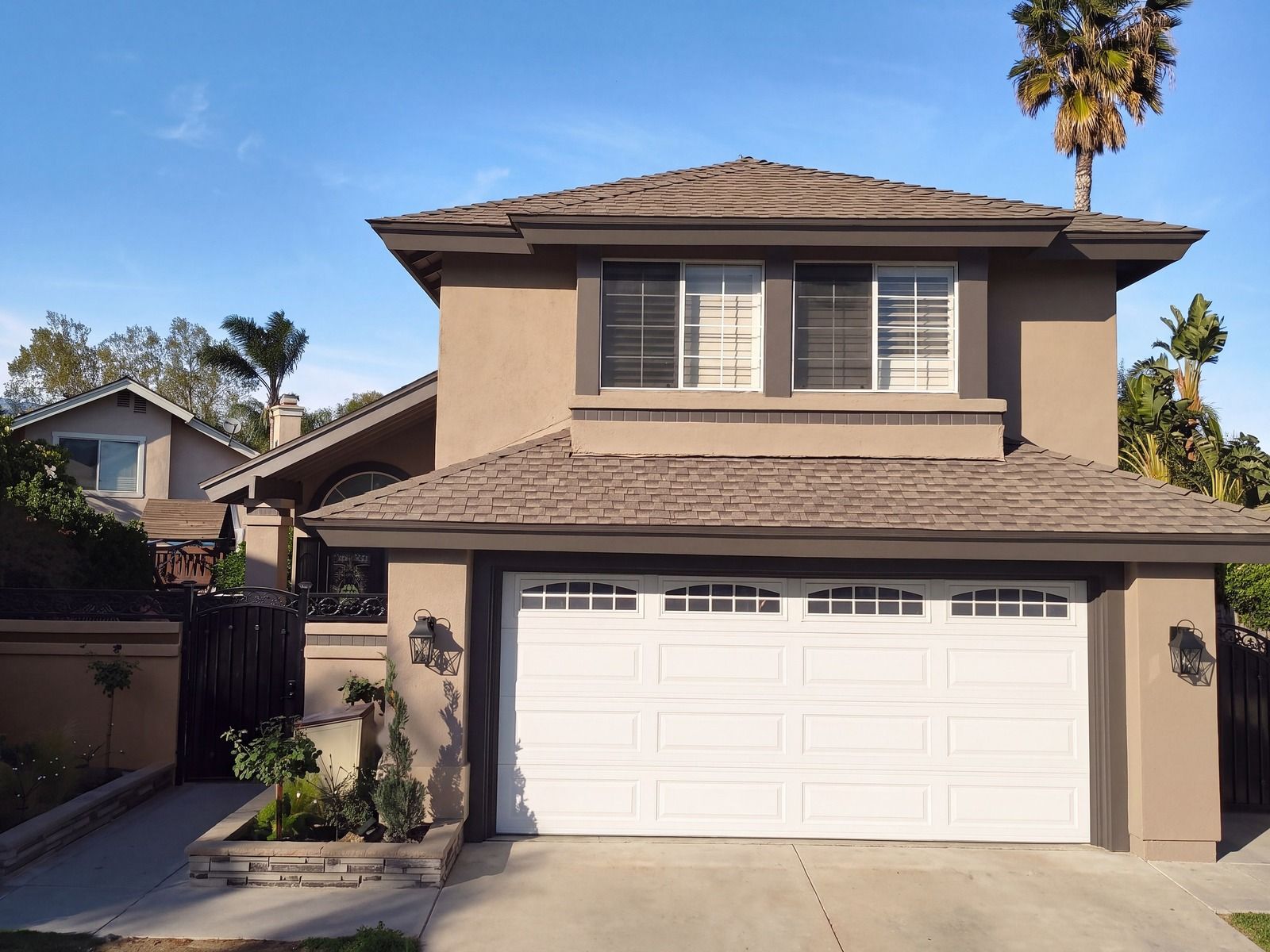 Canyon Taupe palette, digital rendering: warm taupe stucco, dark brown trim, a white garage door