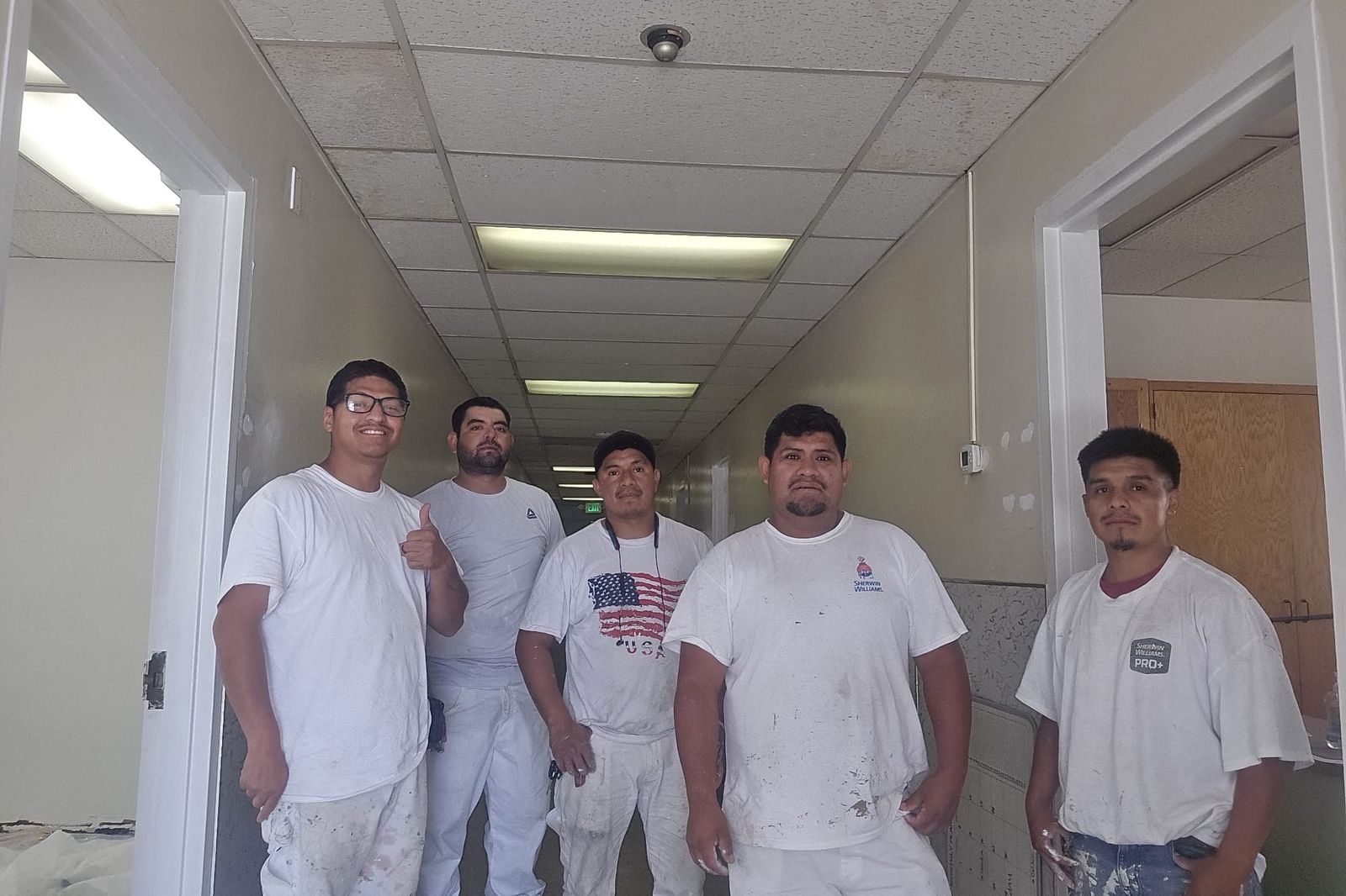 The Black Horse Painting crew in front of a finished home